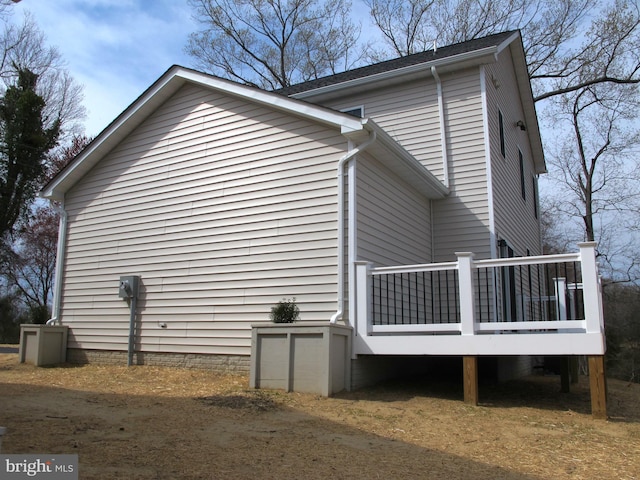 view of property exterior with a deck