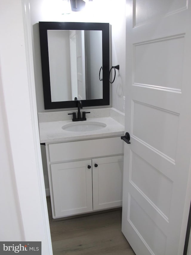 bathroom with wood finished floors and vanity