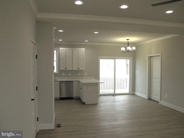 kitchen with light wood-type flooring, a peninsula, ornamental molding, and stainless steel dishwasher