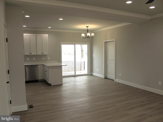 kitchen featuring wood finished floors, a peninsula, stainless steel dishwasher, baseboards, and ornamental molding