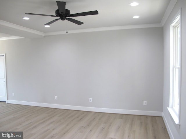 unfurnished room with baseboards, crown molding, and light wood-style floors