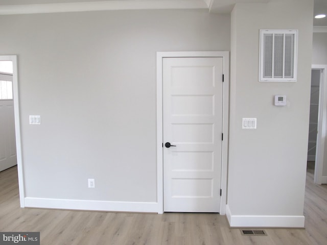 interior space with light wood-type flooring, baseboards, and visible vents