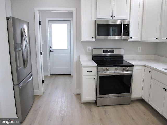 kitchen featuring white cabinetry, light countertops, light wood-style floors, and stainless steel appliances