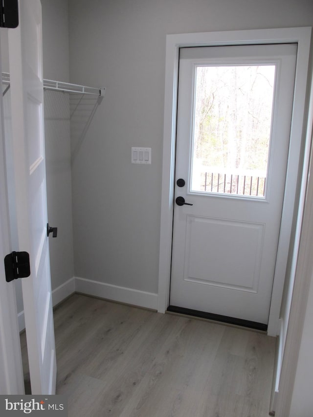 laundry room featuring baseboards and light wood-style floors
