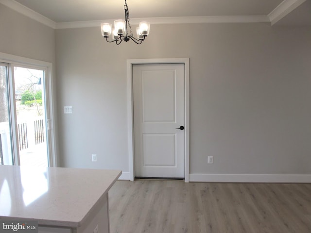 unfurnished dining area featuring an inviting chandelier, ornamental molding, baseboards, and light wood-type flooring