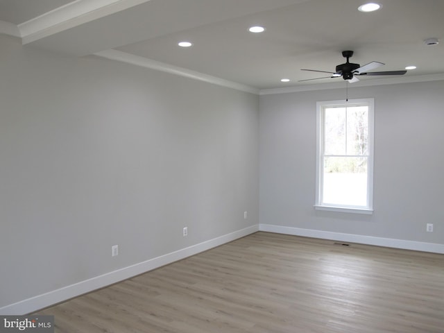 empty room with crown molding, light wood finished floors, baseboards, recessed lighting, and a ceiling fan