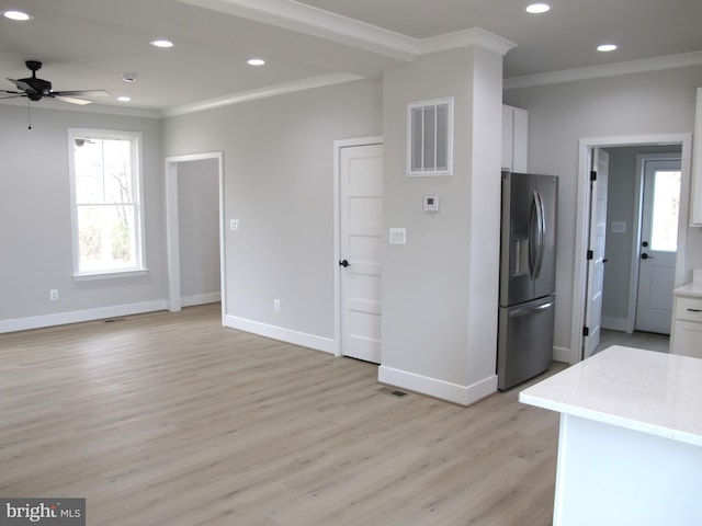 kitchen with white cabinets, a wealth of natural light, stainless steel fridge with ice dispenser, and visible vents