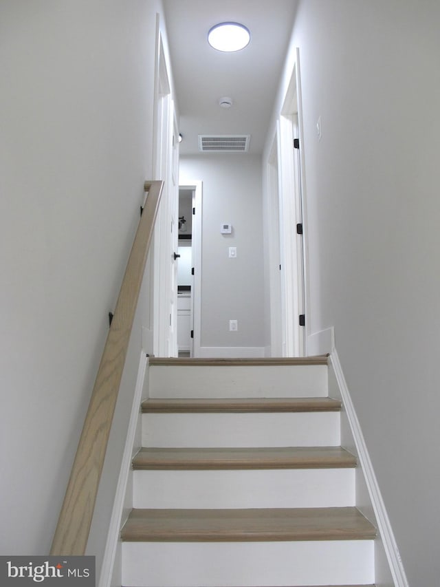 staircase featuring visible vents