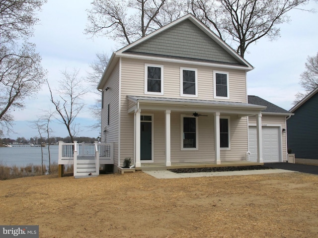 view of front of property with a porch, driveway, a garage, and ceiling fan