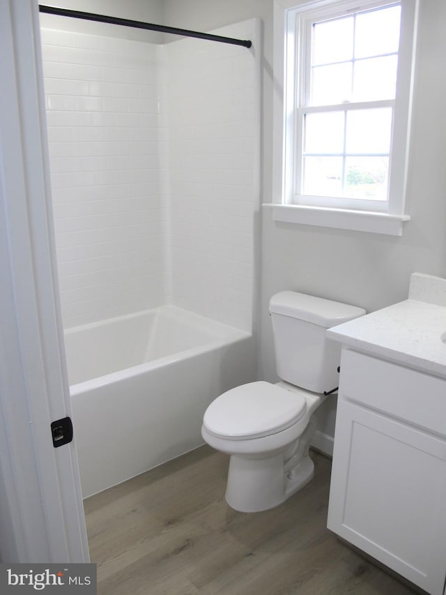 full bath with toilet, vanity, shower / washtub combination, and wood finished floors