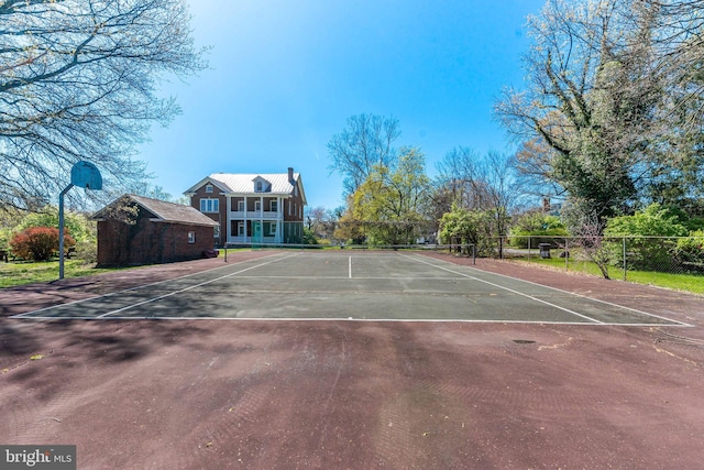 view of tennis court featuring fence
