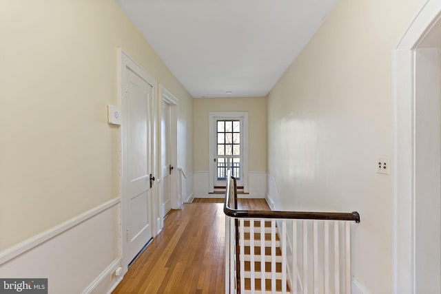 hallway featuring light wood finished floors and an upstairs landing