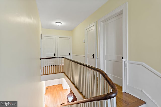 stairs featuring wood finished floors