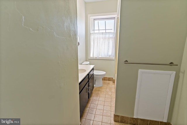 bathroom featuring tile patterned floors, vanity, and toilet
