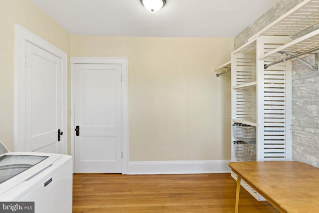 walk in closet featuring washer / clothes dryer and light wood-type flooring