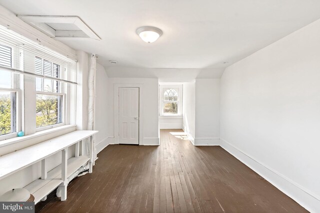 interior space with baseboards and dark wood-style flooring