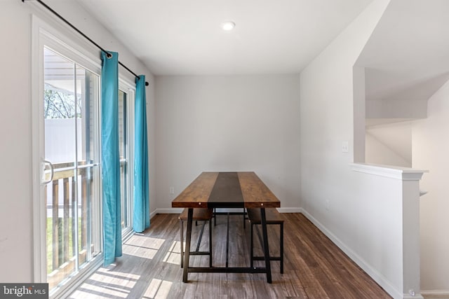 dining space featuring baseboards and wood finished floors