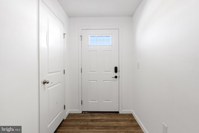 doorway with baseboards and dark wood-style floors
