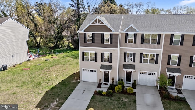 townhome / multi-family property with roof with shingles, a garage, a front yard, and concrete driveway