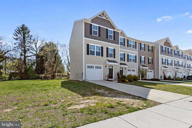view of front of house featuring a front yard, an attached garage, a residential view, and driveway