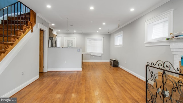 living area featuring baseboards, recessed lighting, stairway, light wood-style flooring, and crown molding