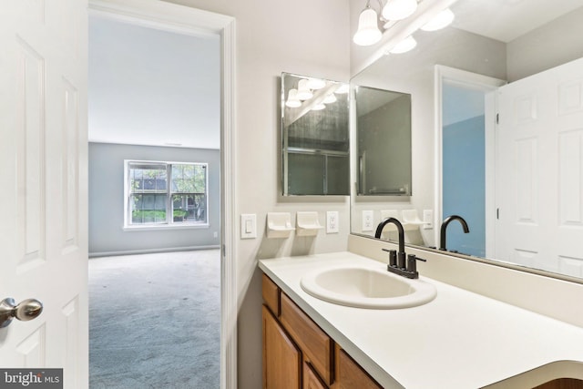 bathroom with a chandelier and vanity