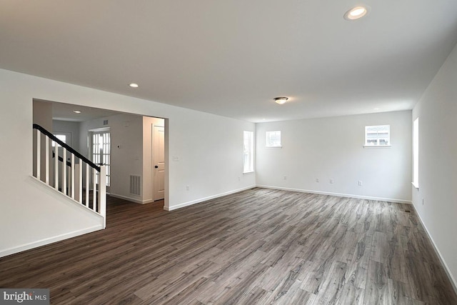 unfurnished room with recessed lighting, baseboards, and wood finished floors