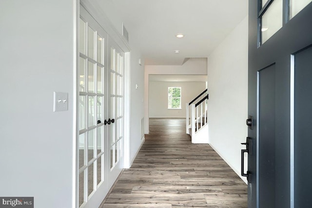 foyer with visible vents, stairway, wood finished floors, french doors, and baseboards