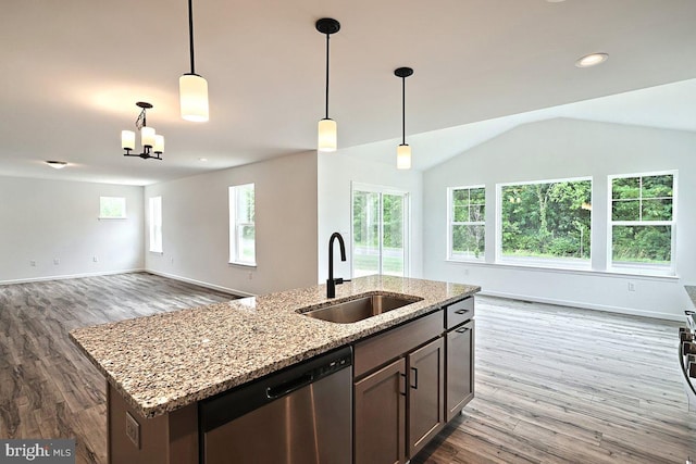 kitchen featuring a sink, open floor plan, dishwasher, and dark wood finished floors