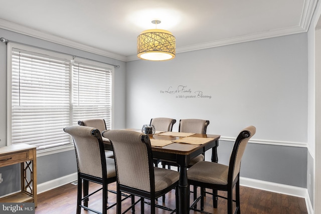 dining area featuring crown molding, baseboards, and dark wood finished floors