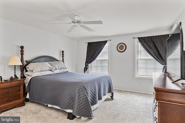 bedroom featuring light carpet, baseboards, and ceiling fan
