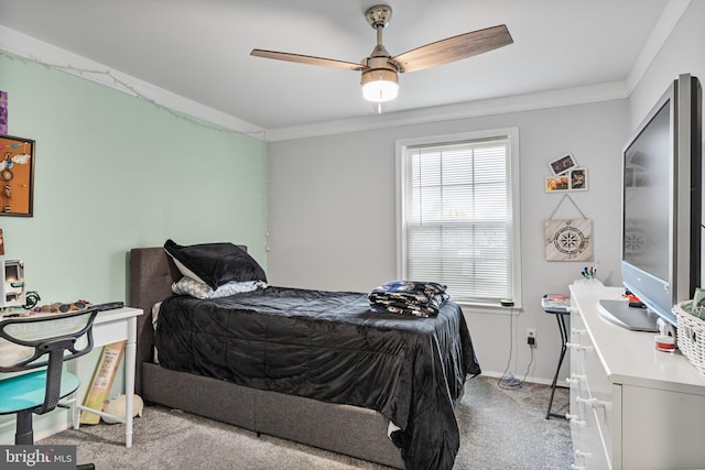 carpeted bedroom featuring crown molding, ceiling fan, and baseboards