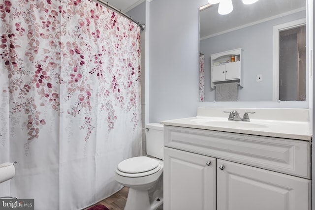 bathroom with a shower with shower curtain, vanity, crown molding, toilet, and wood finished floors