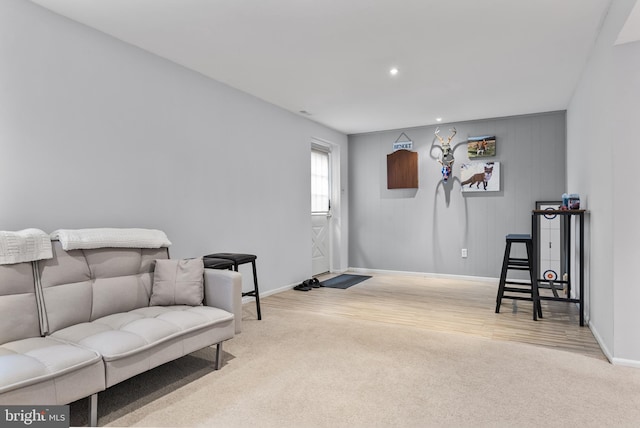 sitting room with wood finished floors, recessed lighting, baseboards, and carpet floors