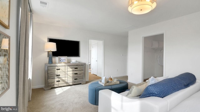 living area with light colored carpet, visible vents, and baseboards
