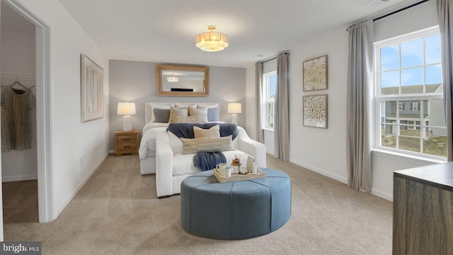 bedroom featuring baseboards and light colored carpet