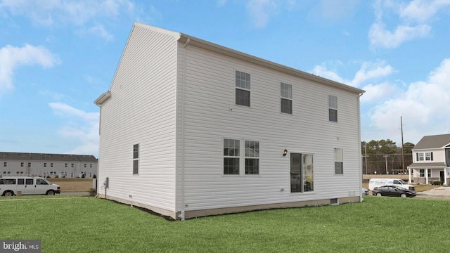 back of property with a lawn