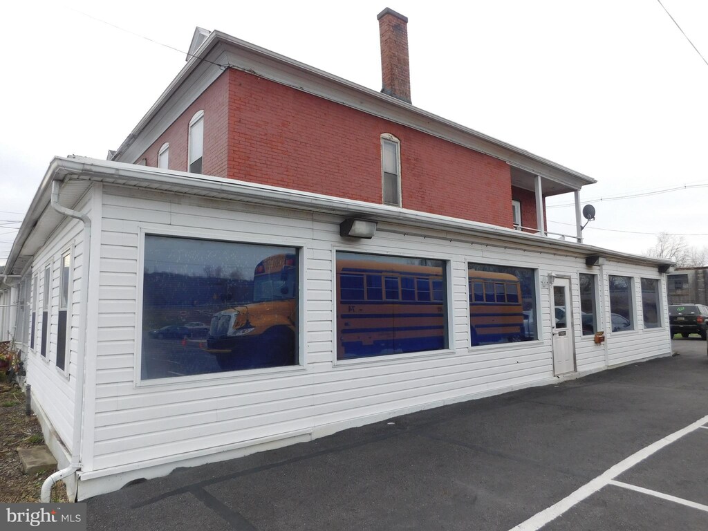 216 S Wayne St, Lewistown, PA 17044 - rear view of house featuring a chimney and brick siding