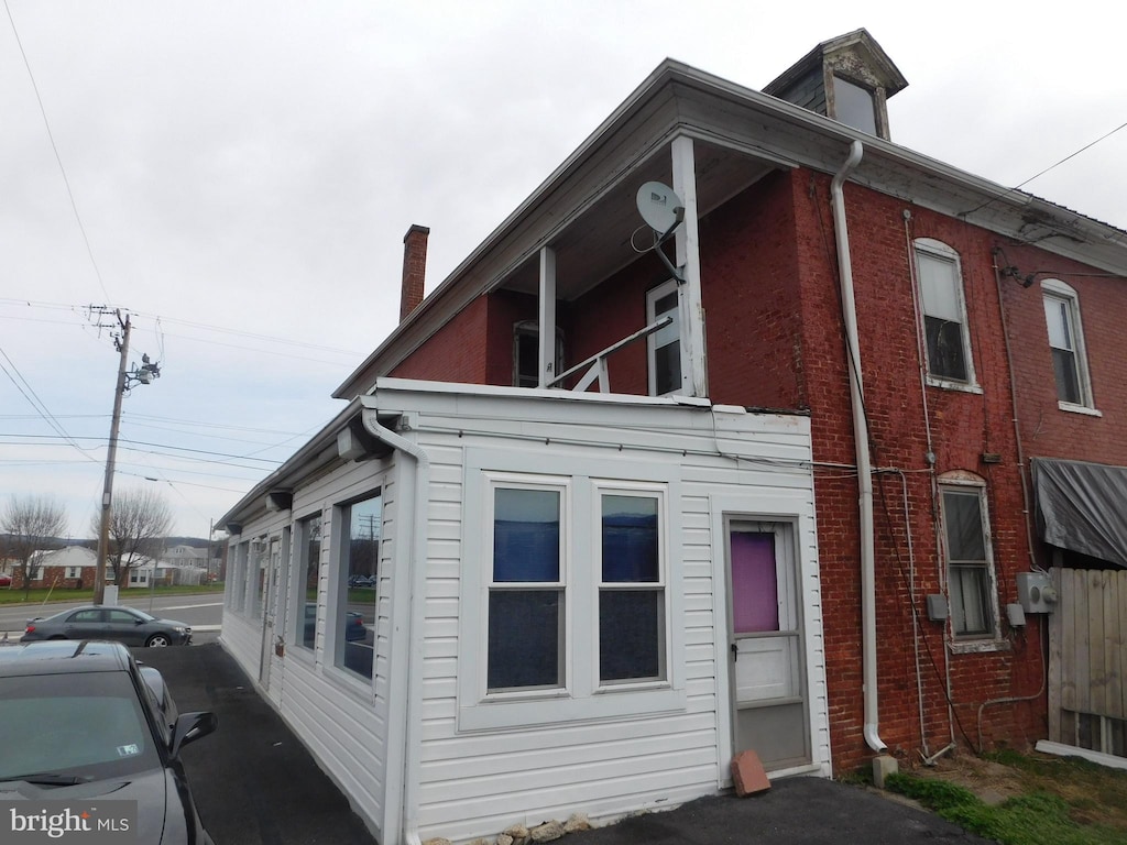216 S Wayne St, Lewistown, PA 17044 - view of property exterior with a chimney