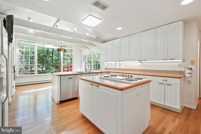 kitchen featuring stainless steel dishwasher, a baseboard heating unit, light wood finished floors, and white electric stovetop