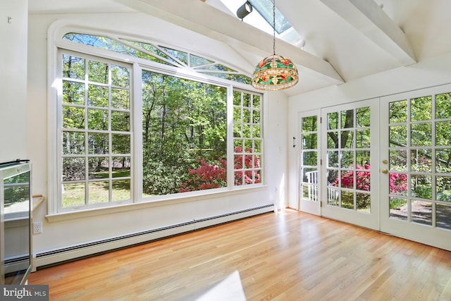 unfurnished sunroom featuring a skylight, a baseboard radiator, french doors, and a wealth of natural light