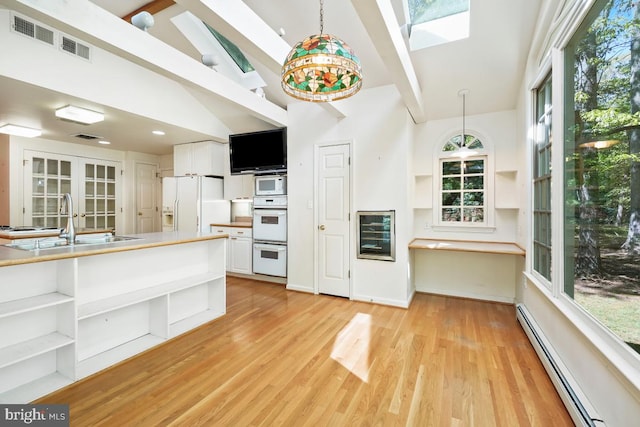 kitchen featuring open shelves, a sink, white appliances, beverage cooler, and a baseboard radiator