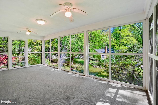 unfurnished sunroom with ceiling fan