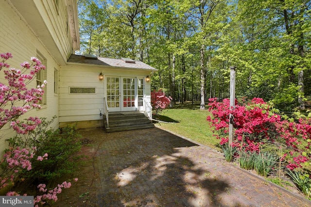 view of yard featuring french doors, entry steps, and a patio area