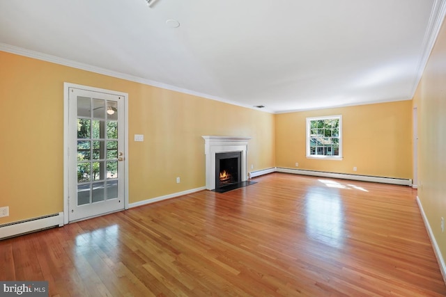 unfurnished living room with a healthy amount of sunlight, crown molding, and baseboard heating