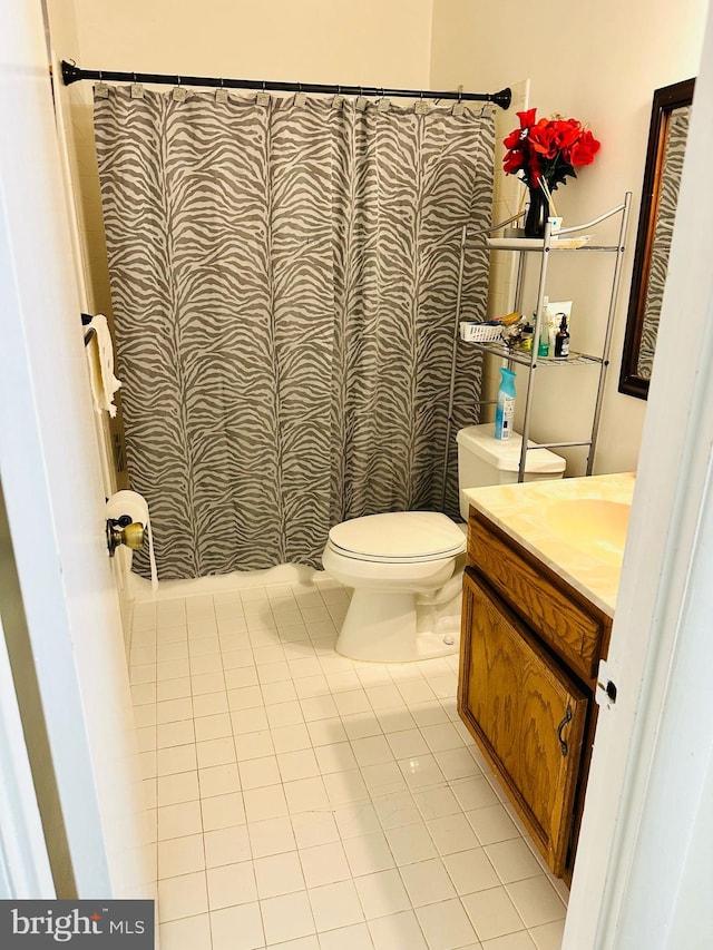 6112 Armor Dr, Clinton, MD 20735 - full bath with tile patterned floors, toilet, vanity, and a shower with curtain