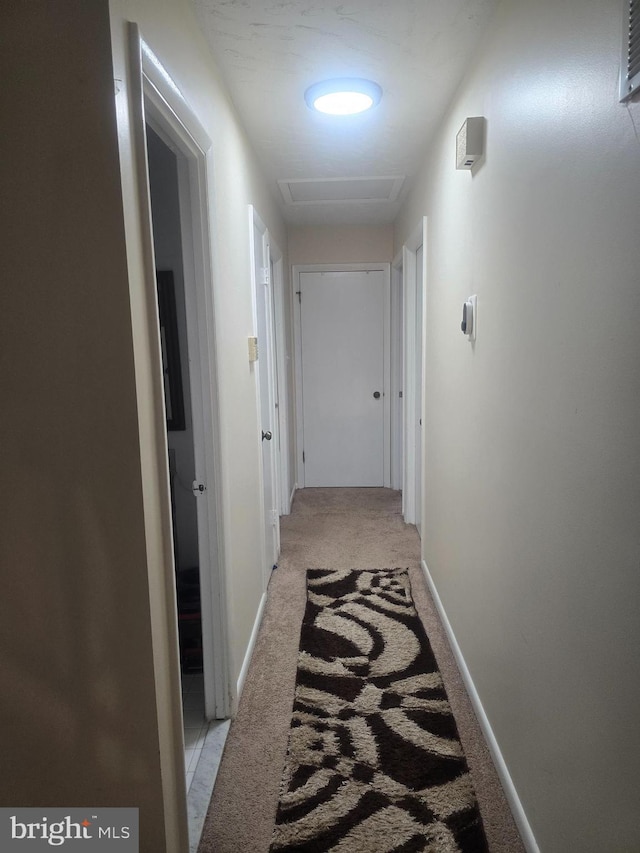 6112 Armor Dr, Clinton, MD 20735 - hallway featuring light colored carpet, attic access, and baseboards