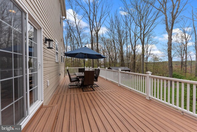 wooden deck with outdoor dining area
