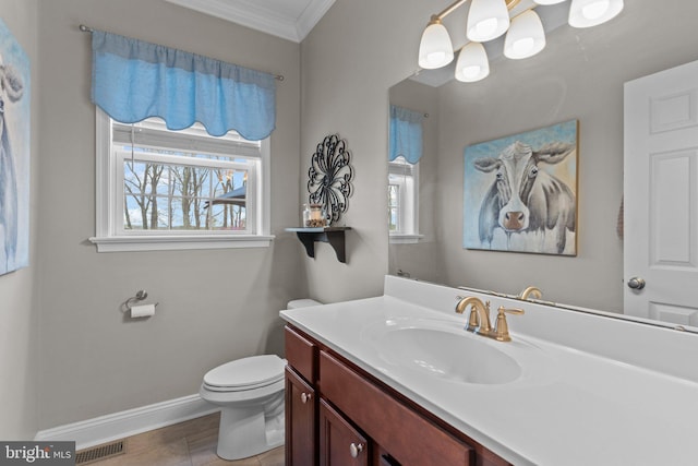 bathroom with toilet, baseboards, visible vents, crown molding, and vanity