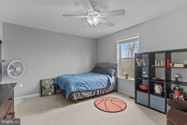 bedroom with light carpet, a ceiling fan, visible vents, and baseboards